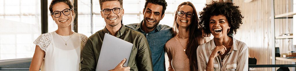 Diverse coworkers smiling together at office