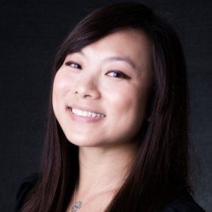 A woman with long hair and a smile.