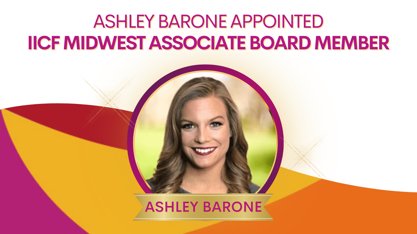 A woman with long hair is smiling for the camera.