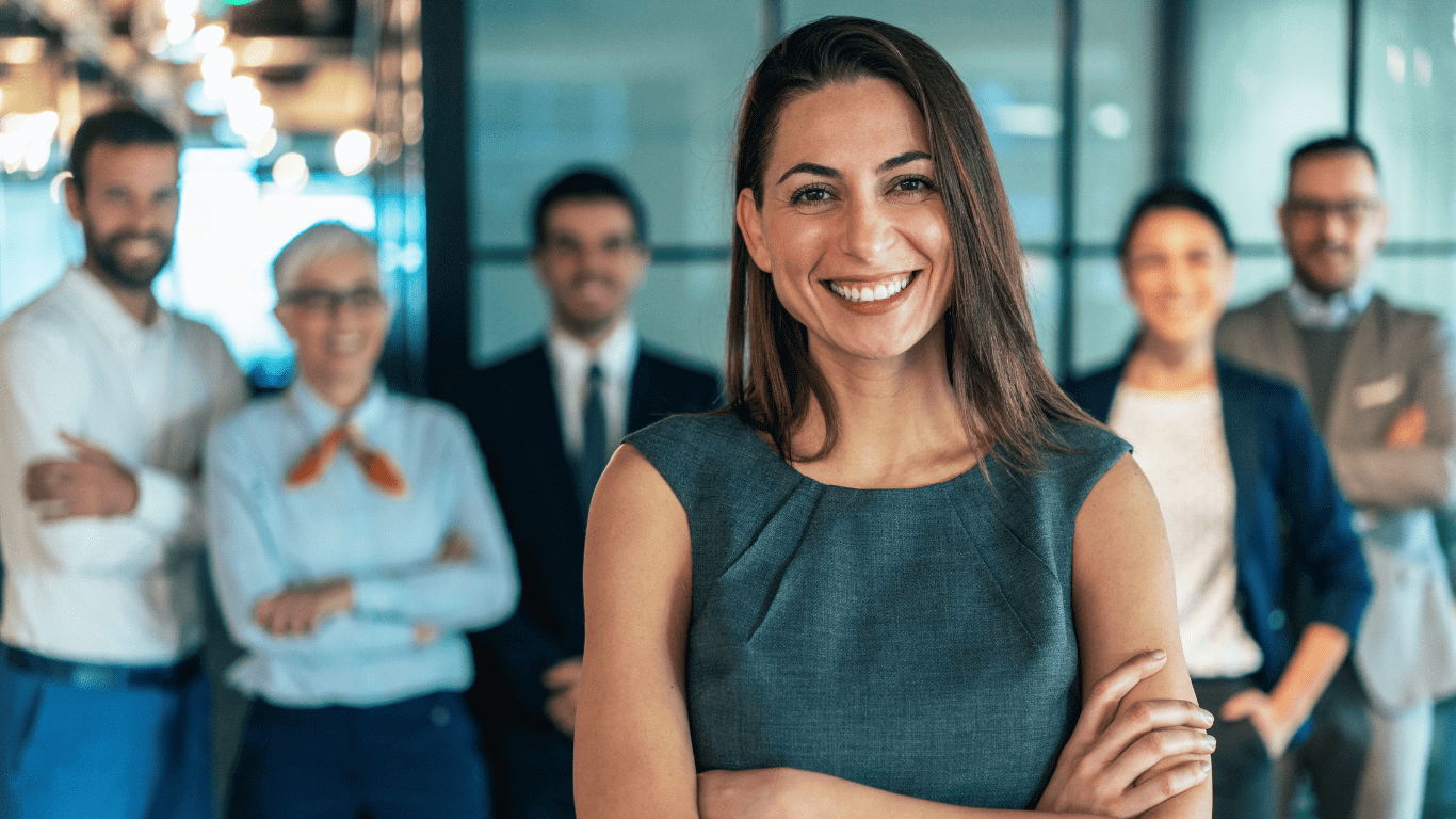 A woman standing in front of other people.