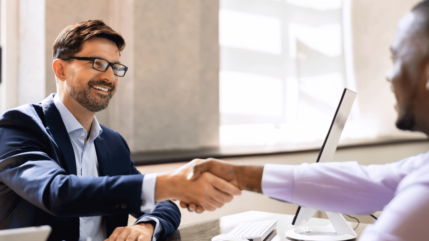 two people are shaking hands with each other