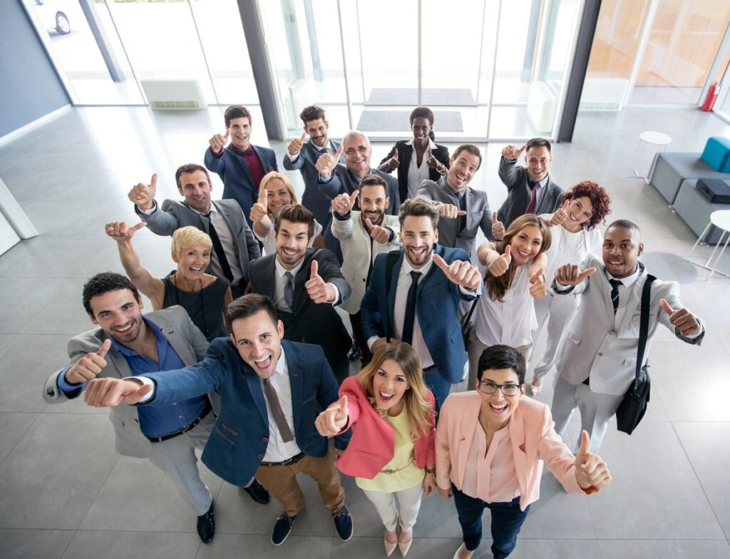 Group of professionals giving thumbs up.